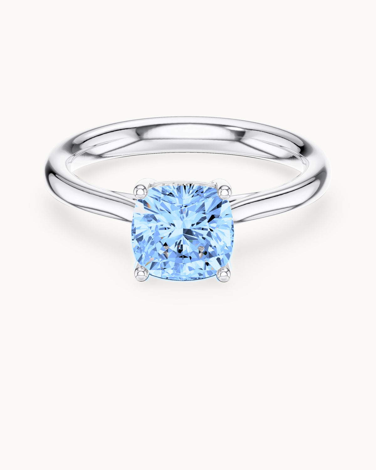 Ishira cushion solitaire ring in white gold, shown with a blue center diamond (digitally colored render)