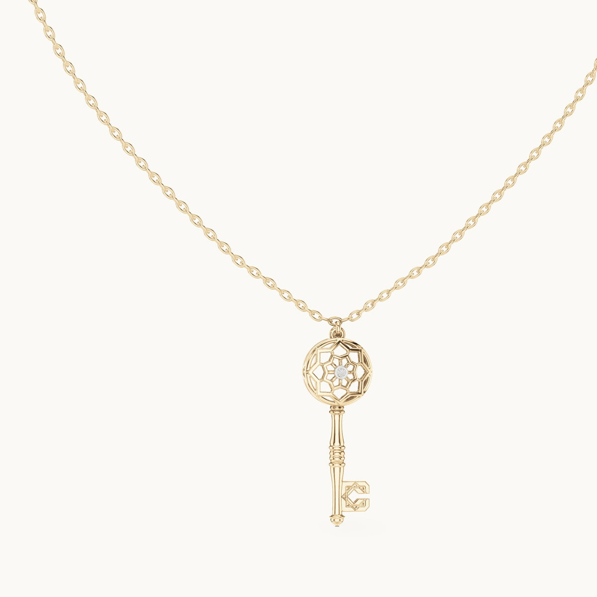 Round lab-grown diamond filigree key pendant in yellow gold, 0.008 CT TW, view 1