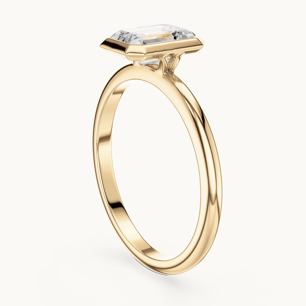 Emerald-cut lab-grown diamond bezel solitaire engagement ring in yellow gold, 1.00 CT TW, view 1