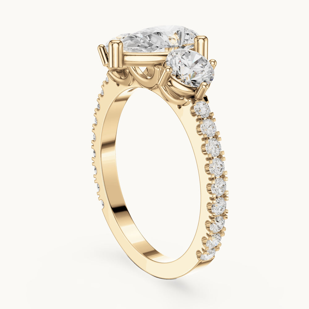 Round and pear lab-grown diamond three-stone pavé engagement ring in yellow gold, 2.024 CT TW, view 1
