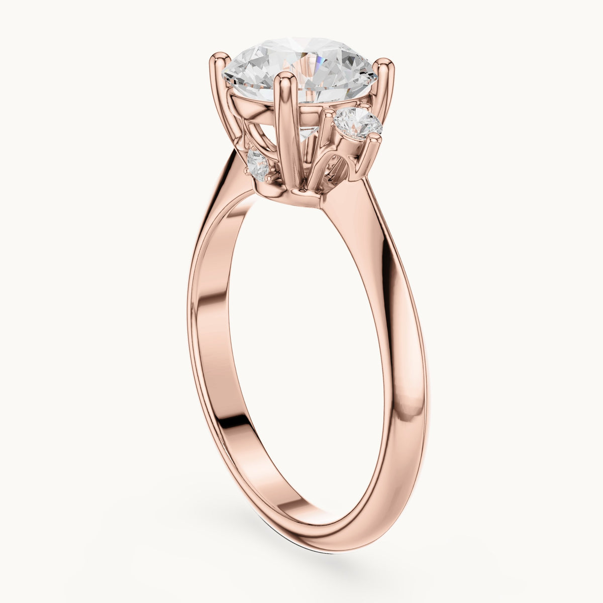 Round lab-grown diamond three-stone engagement ring with hidden accents in rose gold, 2.16 CT TW, view 1