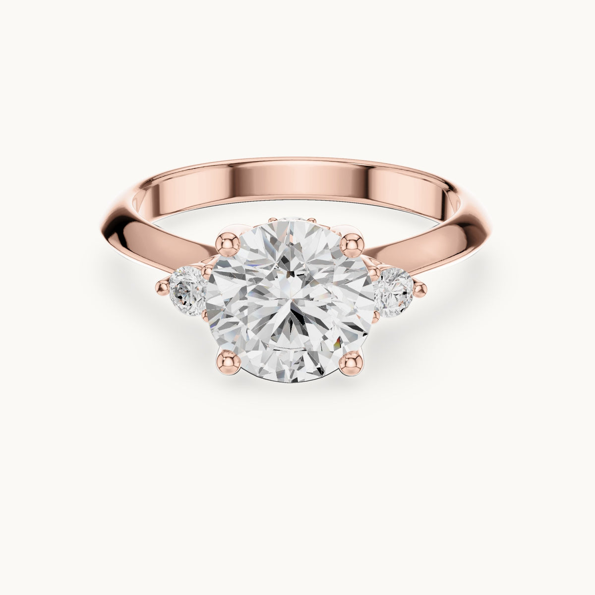 Round lab-grown diamond three-stone engagement ring with hidden accents in rose gold, 2.16 CT TW, view 4