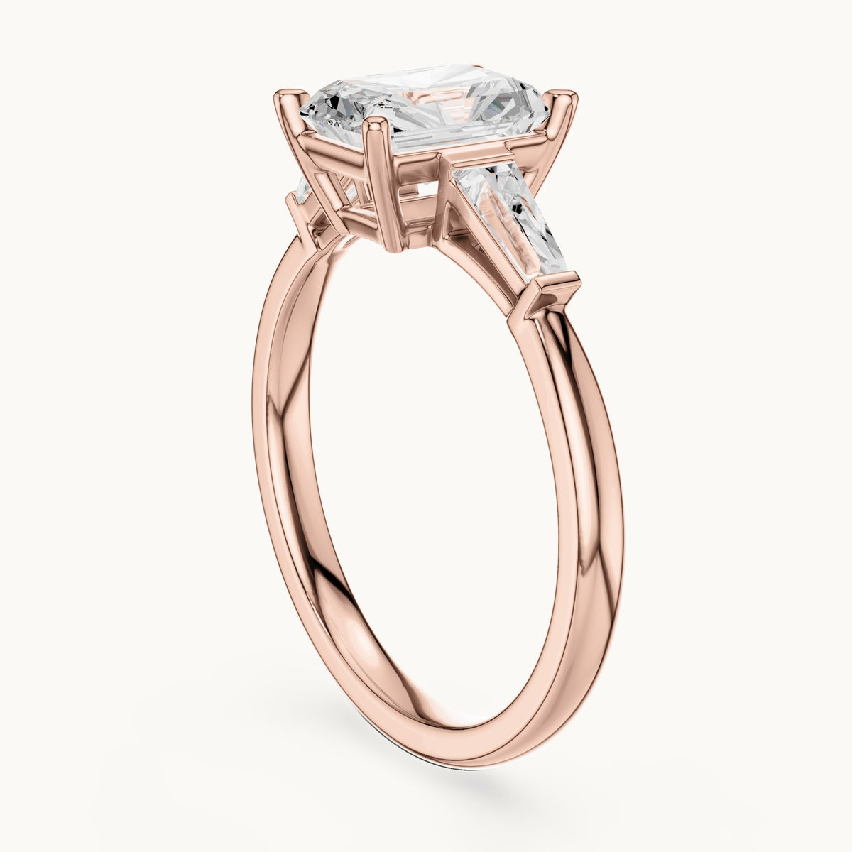 Radiant-cut lab-grown diamond three-stone engagement ring with tapered baguettes in rose gold, 2.07 CT TW, view 1