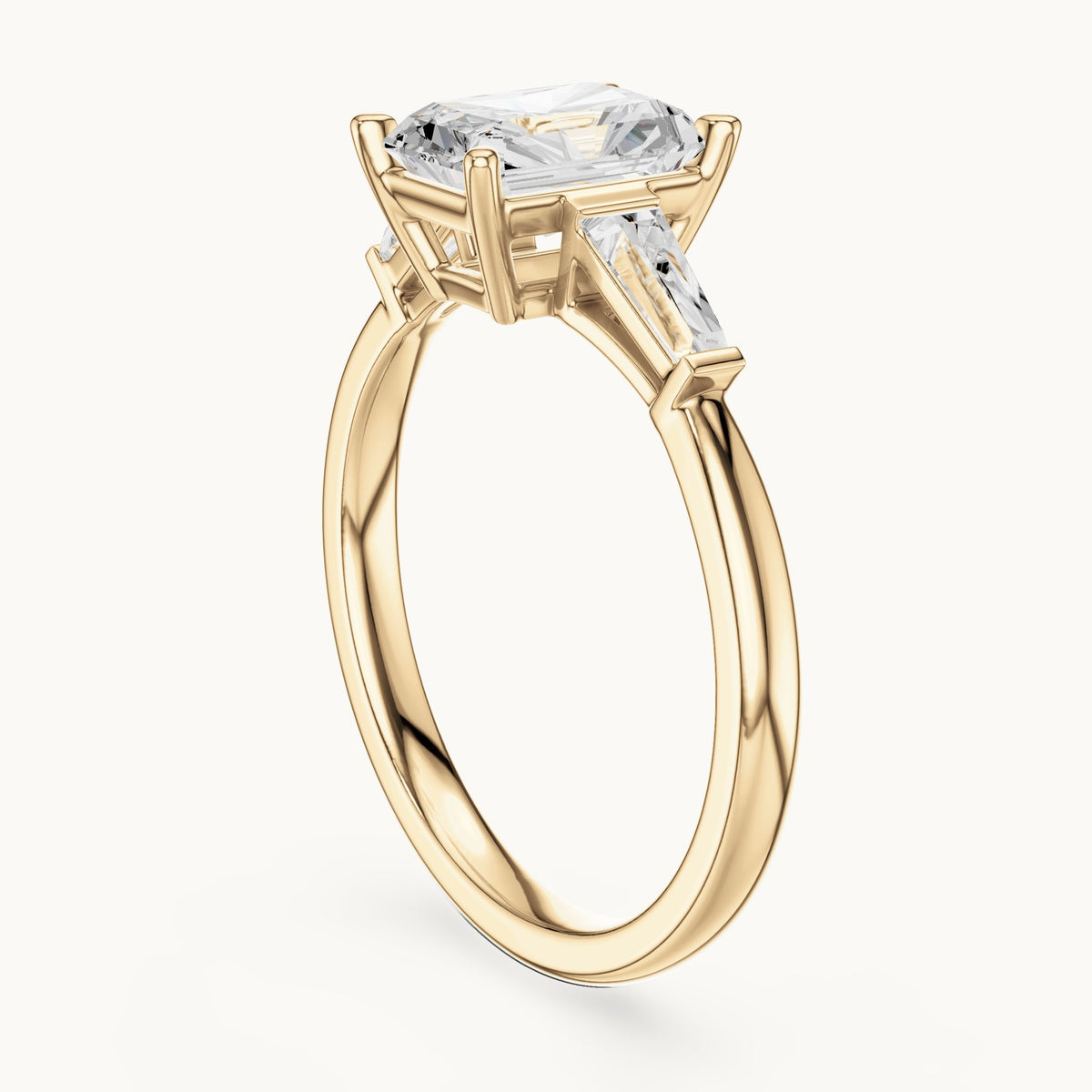 Radiant-cut lab-grown diamond three-stone engagement ring with tapered baguettes in yellow gold, 2.07 CT TW, view 1
