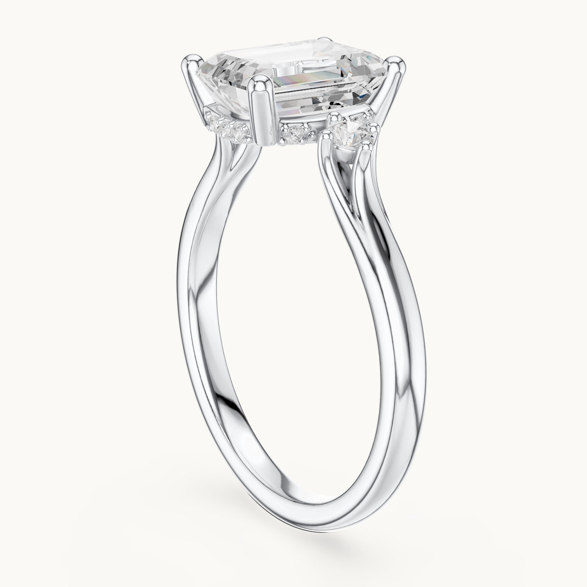Emerald-cut and round lab-grown diamond three-stone engagement ring with hidden halo in white gold, 2.23 CT TW, view 1