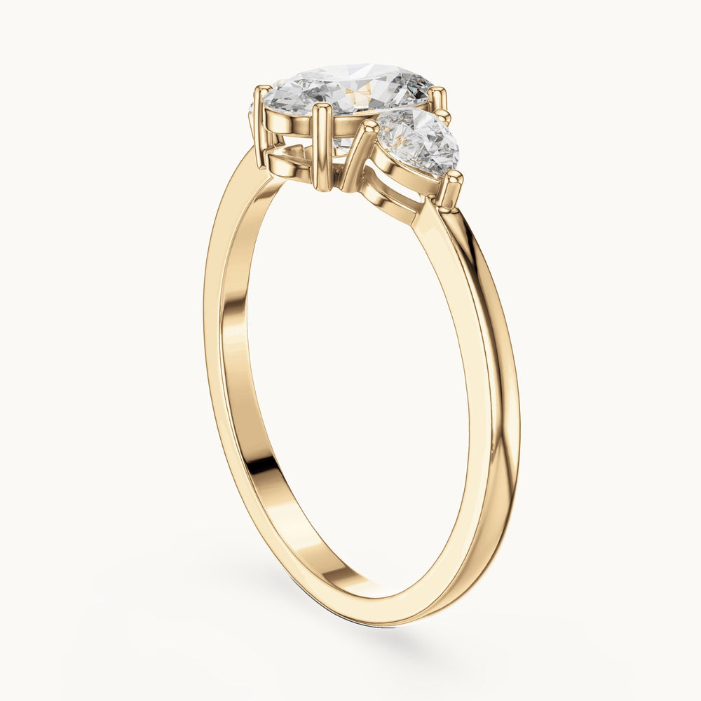Oval lab-grown diamond three-stone engagement ring with pear side stones in yellow gold, 0.93 CT TW, view 1