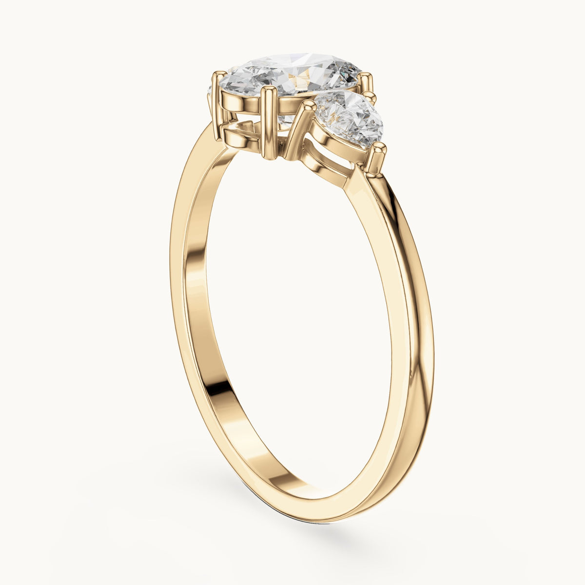 Oval lab-grown diamond three-stone engagement ring with pear side stones in yellow gold, 0.93 CT TW, view 1