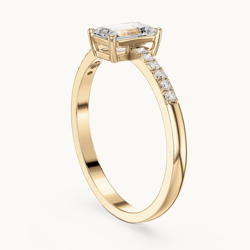 Emerald-cut lab-grown diamond solitaire engagement ring with pavé band in yellow gold, 0.62 CT TW, view 1