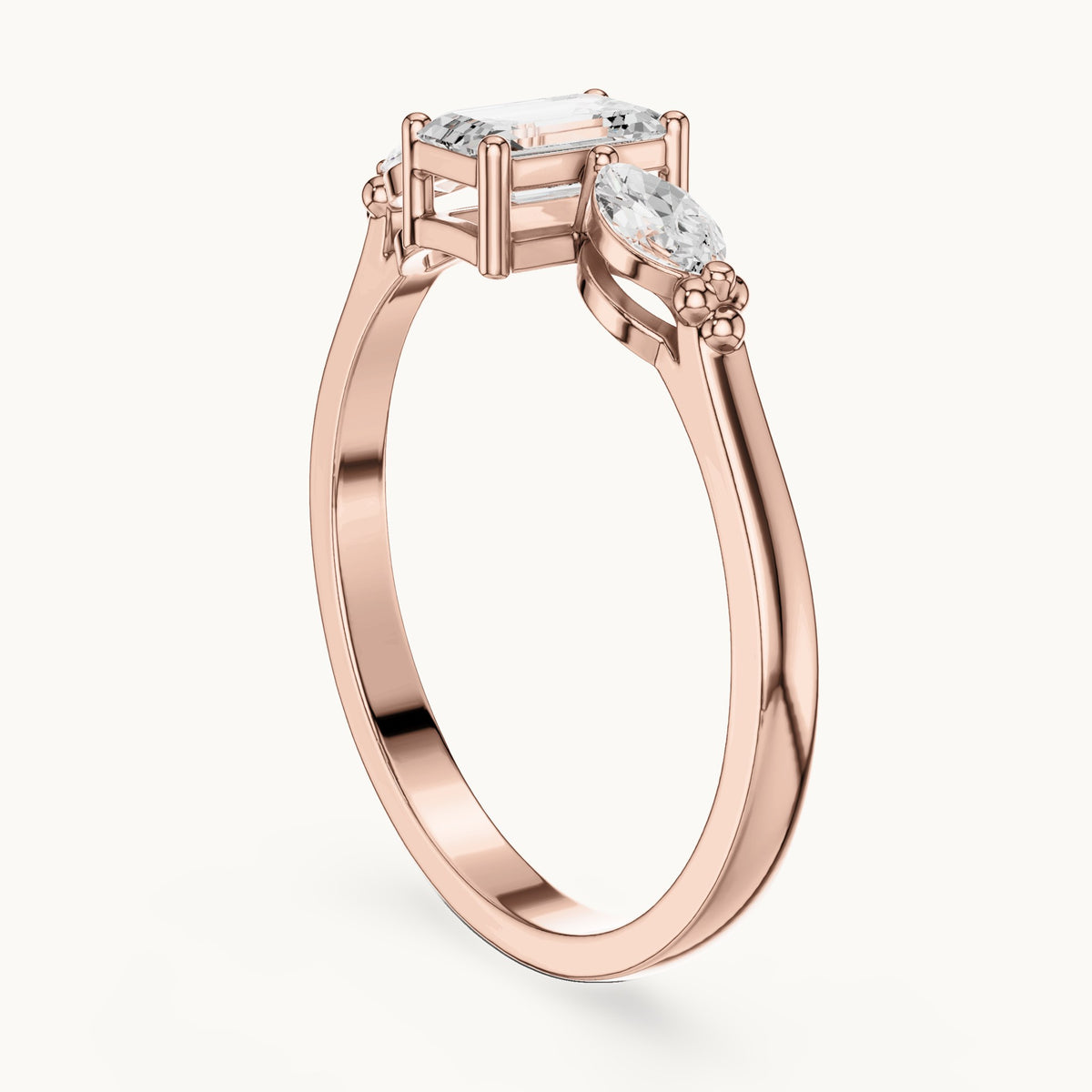 Emerald and marquise lab-grown diamond three-stone engagement ring with side stones in rose gold, 0.55 CT TW, view 1