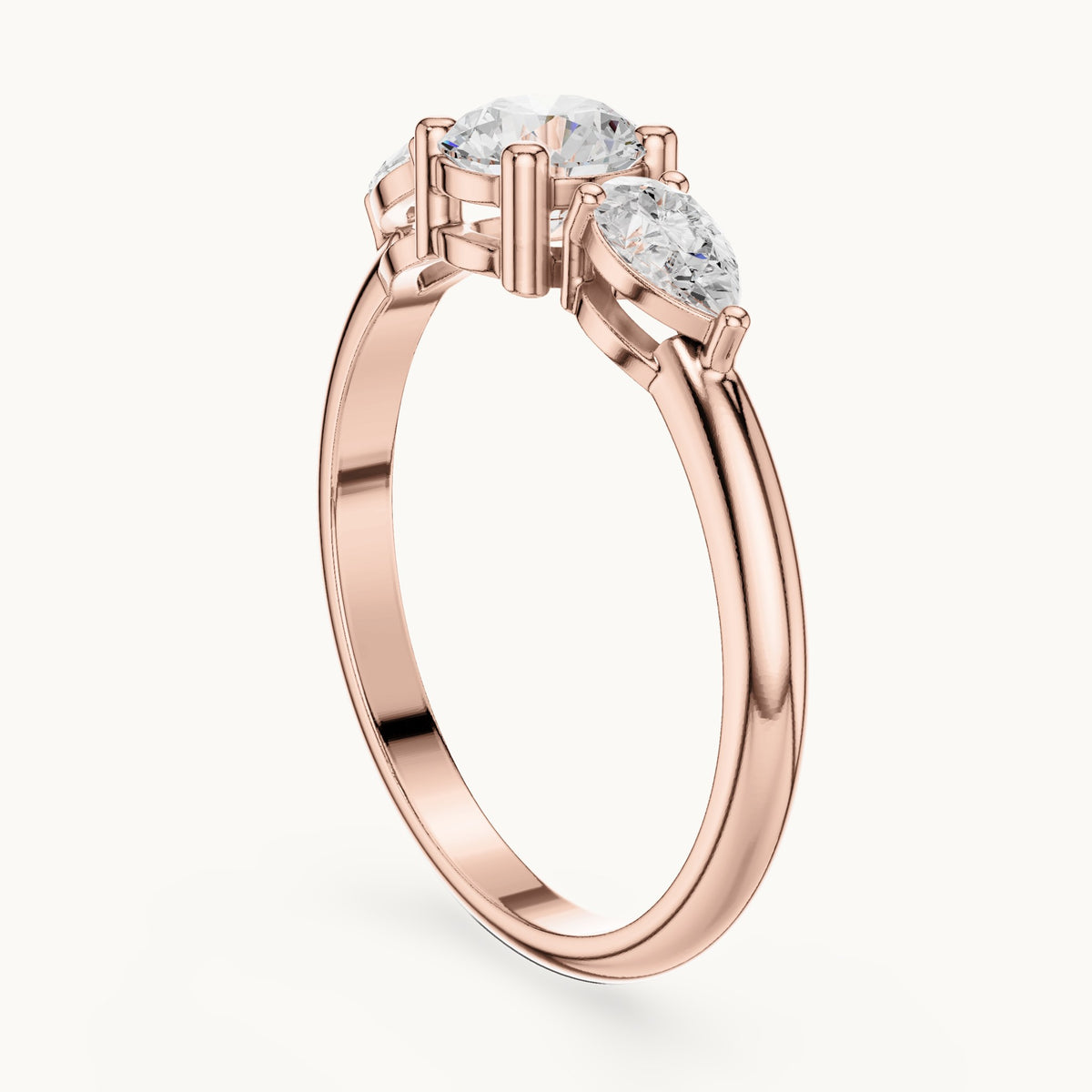 Round and pear lab-grown diamond three-stone engagement ring with side stones in rose gold, 0.81 CT TW, view 1