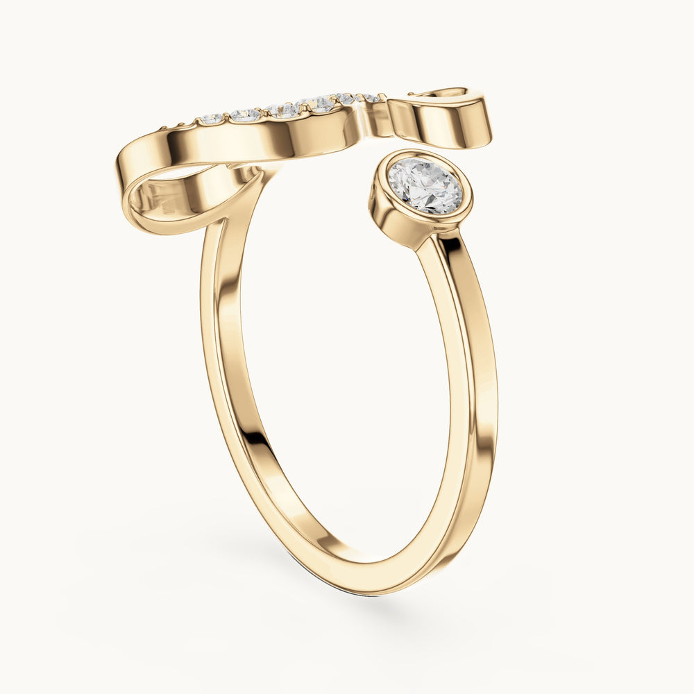 Round lab-grown diamond swirl bypass ring with bezel diamond in yellow gold, 0.228 CT TW, view 1