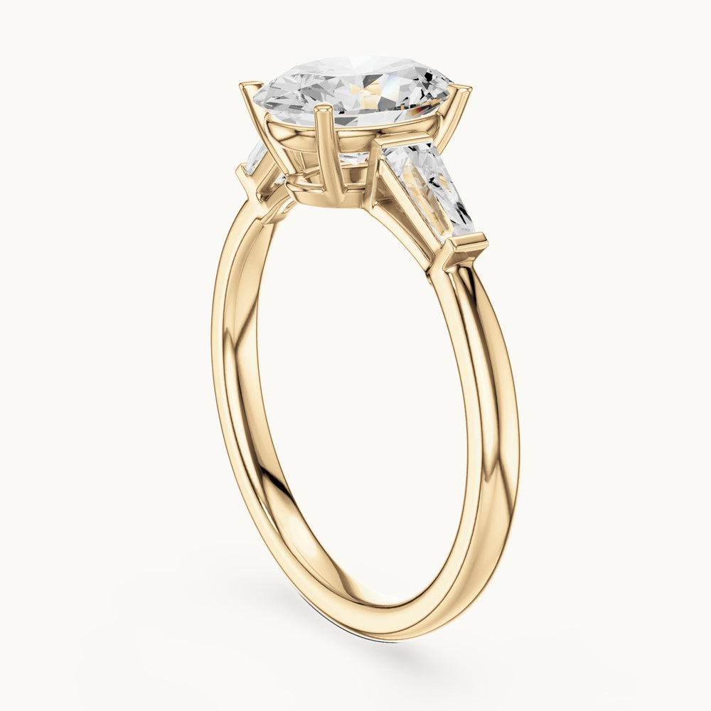 Oval lab-grown diamond three-stone tapered baguette engagement ring in yellow gold, 2.00 CT TW, view 1