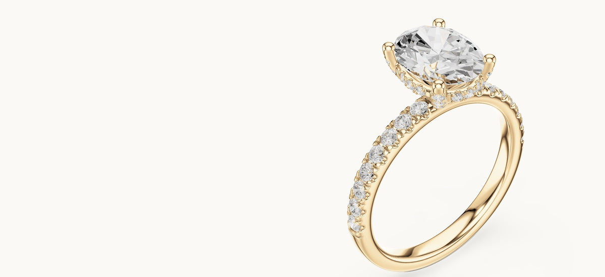 Oval lab-grown diamond engagement ring with hidden halo and pavé band in 14K yellow gold