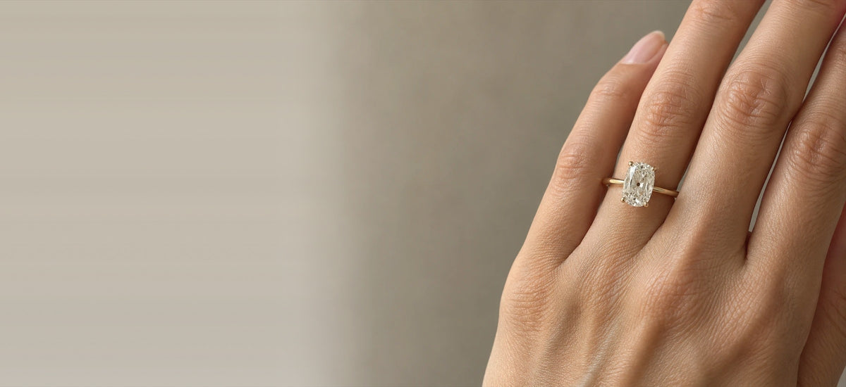 Elongated old mine cut diamond solitaire on a thin yellow gold band (inspiration photo)