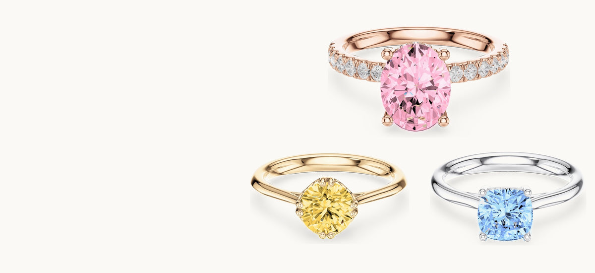 Three Ishira rings in rose, yellow and white gold, shown with pink, yellow and blue center diamonds (digitally colored renders)