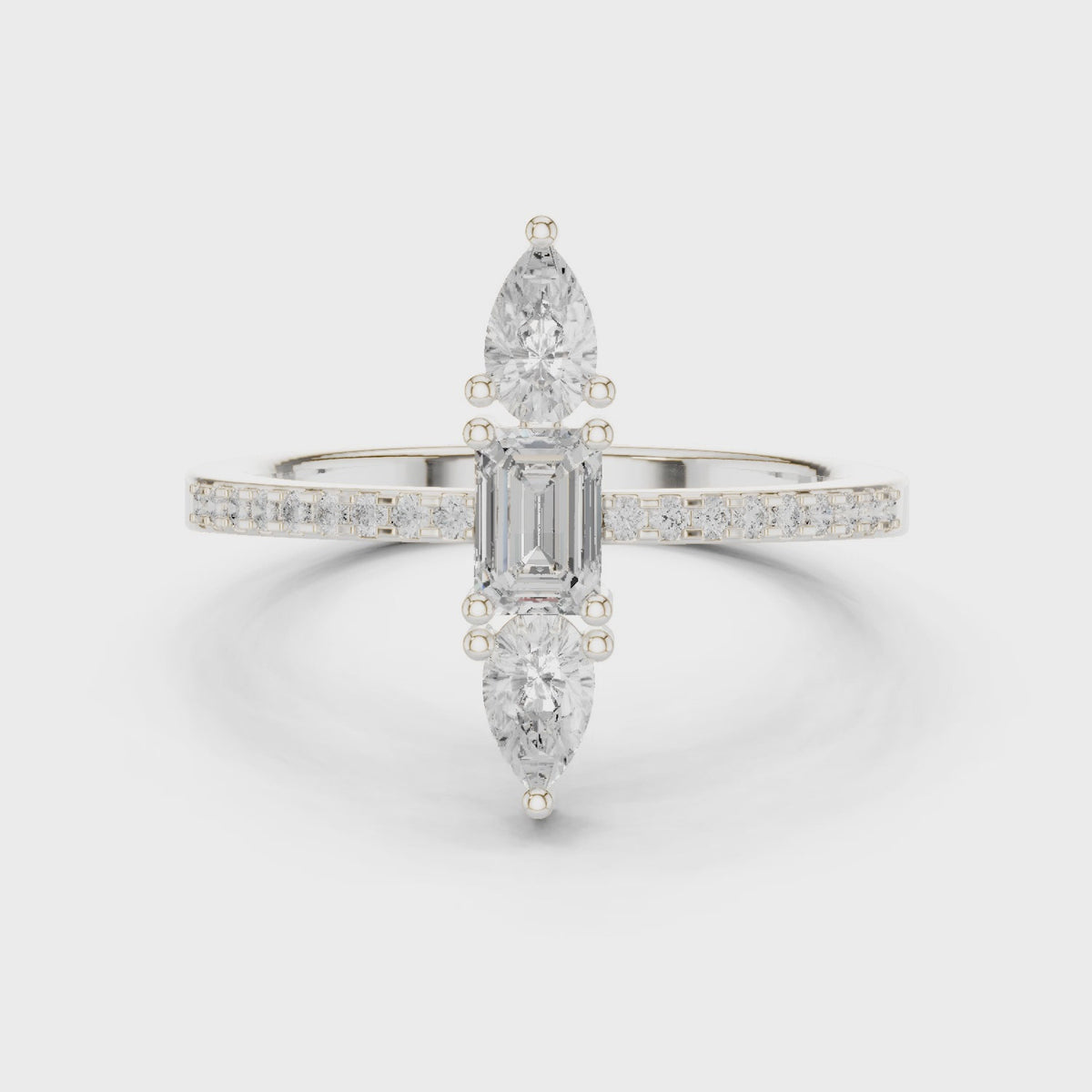 Emerald-cut and pear lab-grown diamond north-south three-stone ring in white gold, 360 degree video