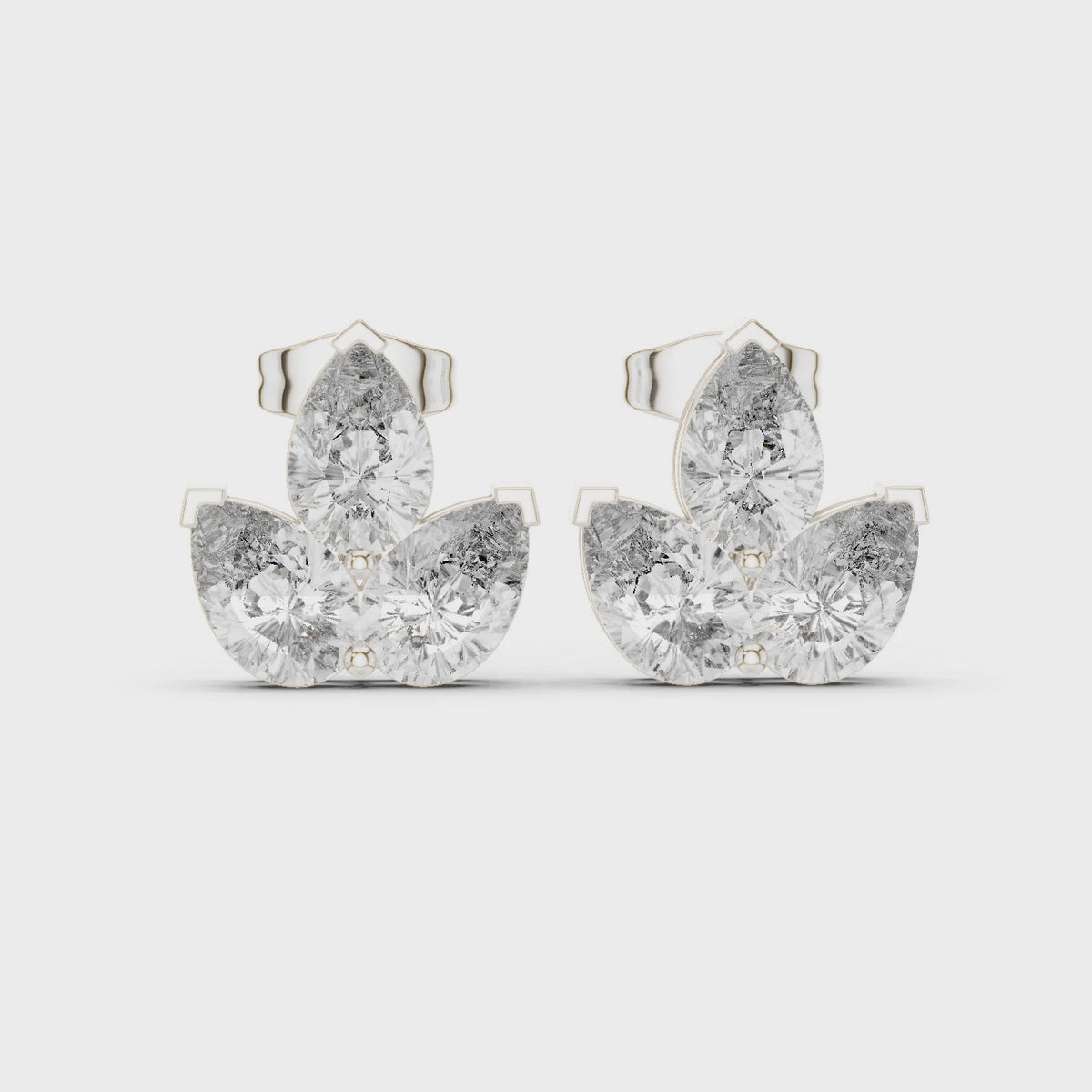 Pear lab-grown diamond three-stone cluster stud earrings in white gold, 360 degree video