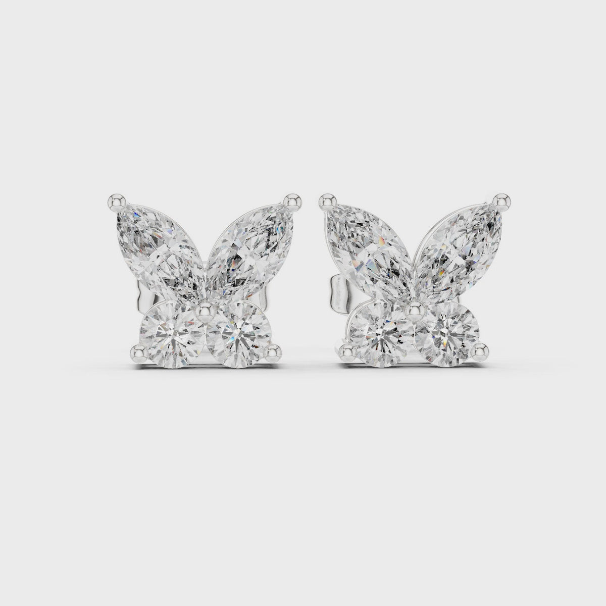 Marquise and round lab-grown diamond butterfly stud earrings in white gold, 360 degree video