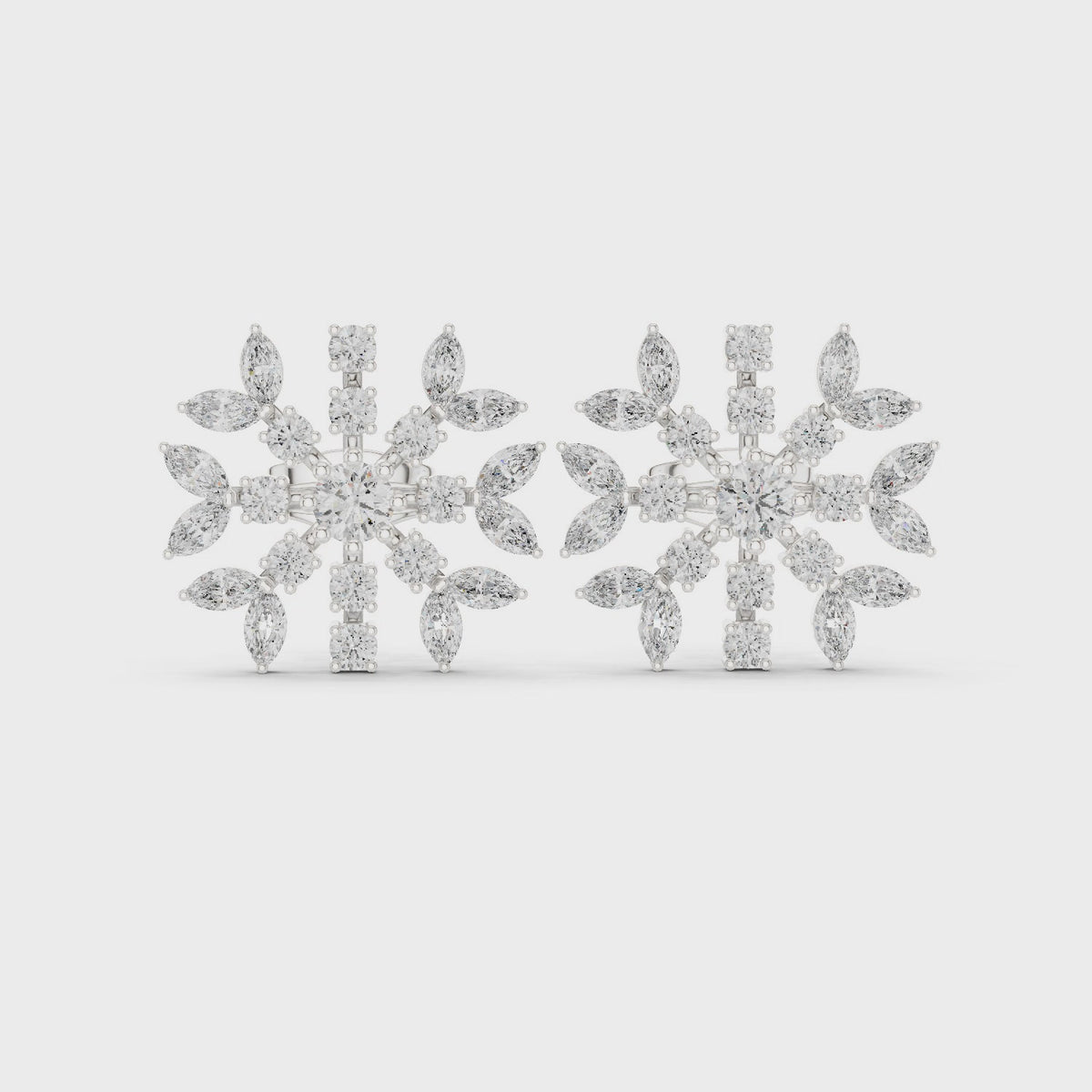 Round and marquise lab-grown diamond snowflake stud earrings in white gold, 360 degree video