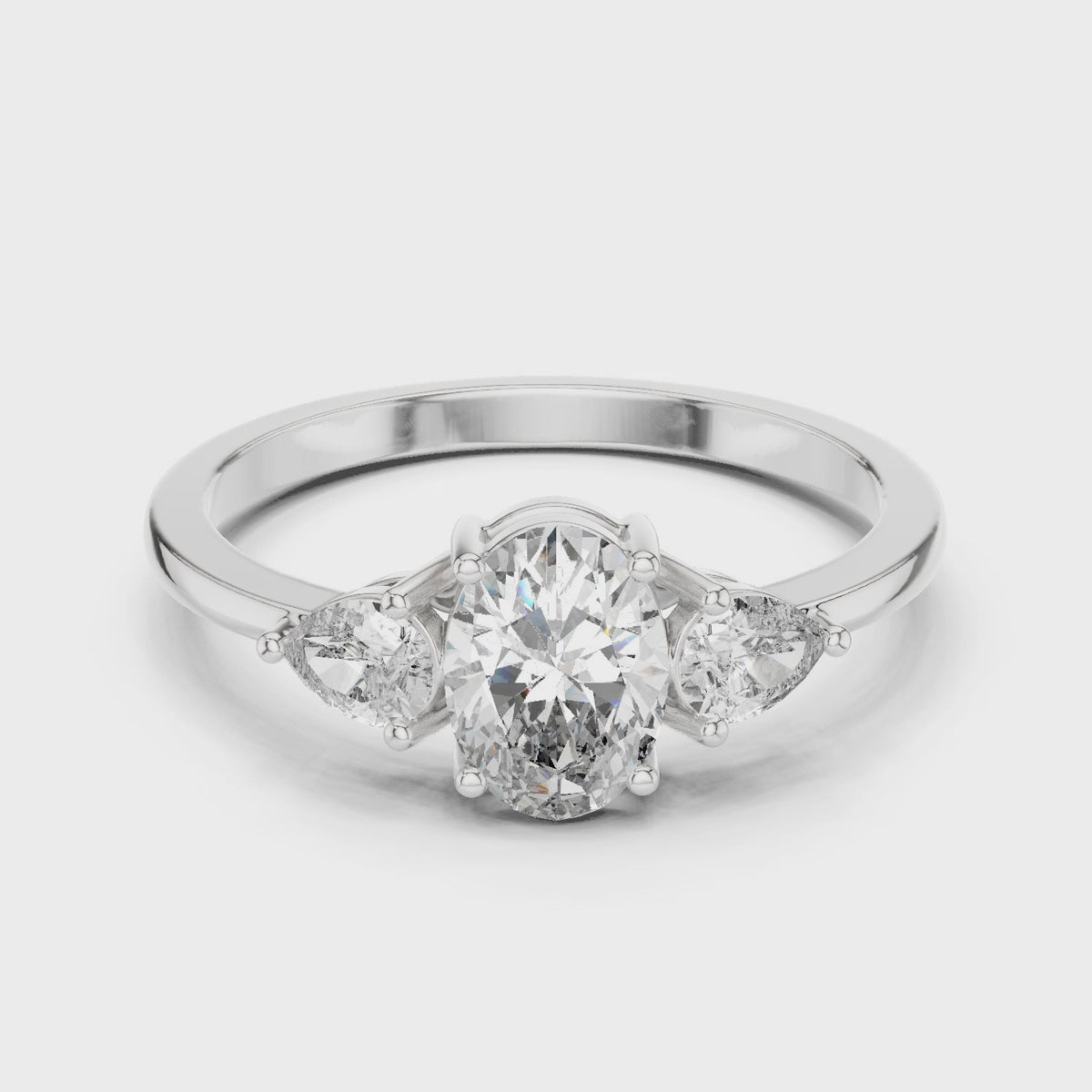 Oval lab-grown diamond three-stone engagement ring with pear side stones in white gold, 360 degree video