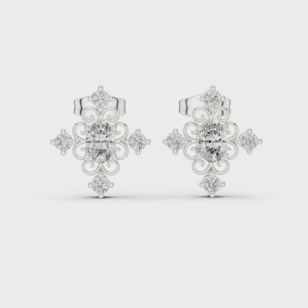 Oval and round lab-grown diamond cross cluster stud earrings in white gold, 360 degree video