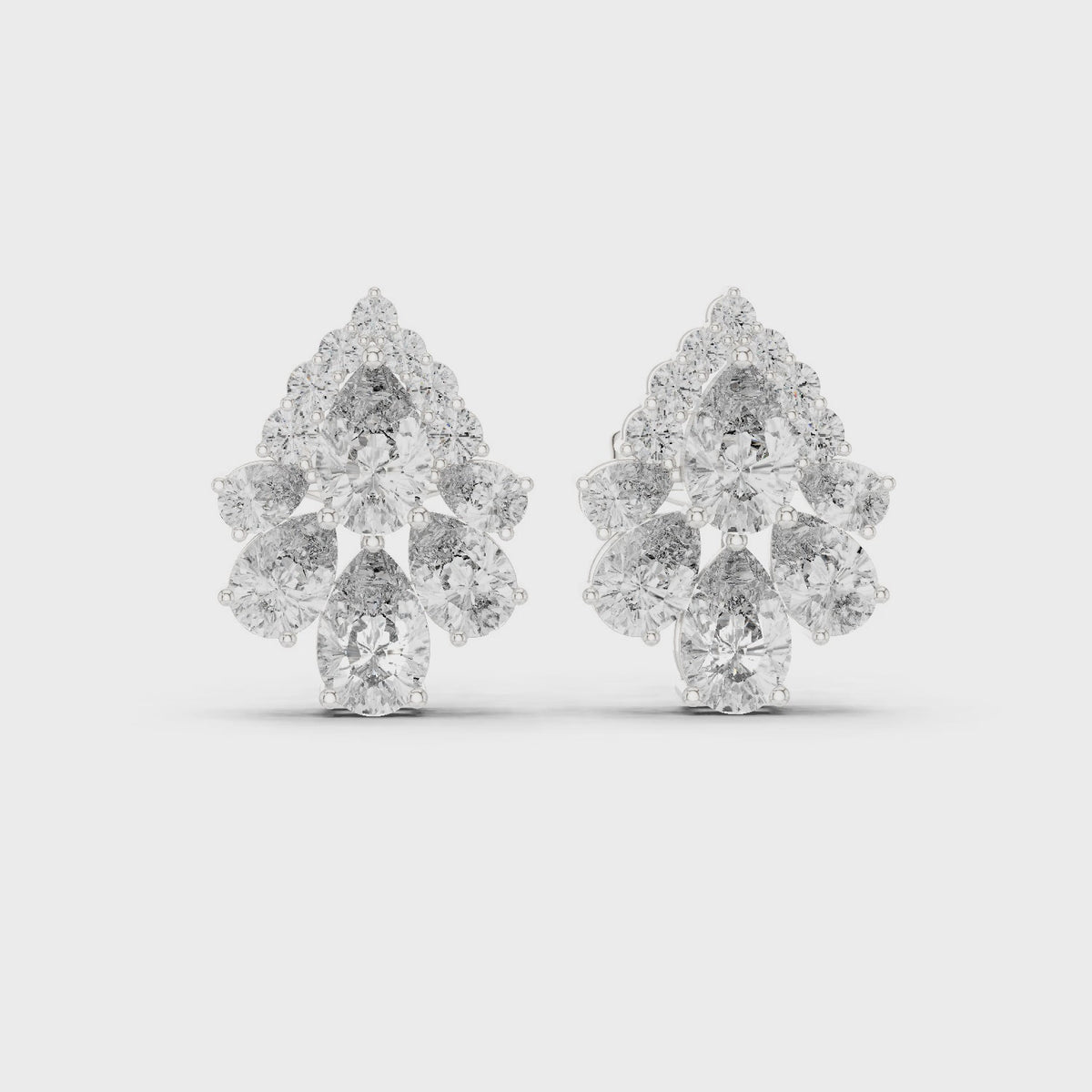 Pear and round lab-grown diamond teardrop cluster stud earrings in white gold, 360 degree video