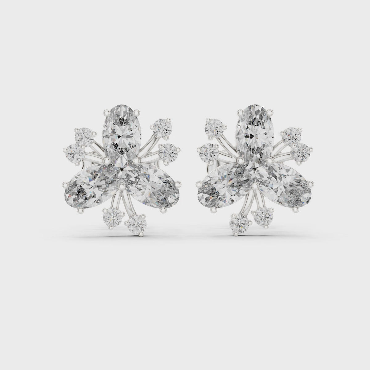 Oval and round lab-grown diamond petal cluster stud earrings in white gold, 360 degree video