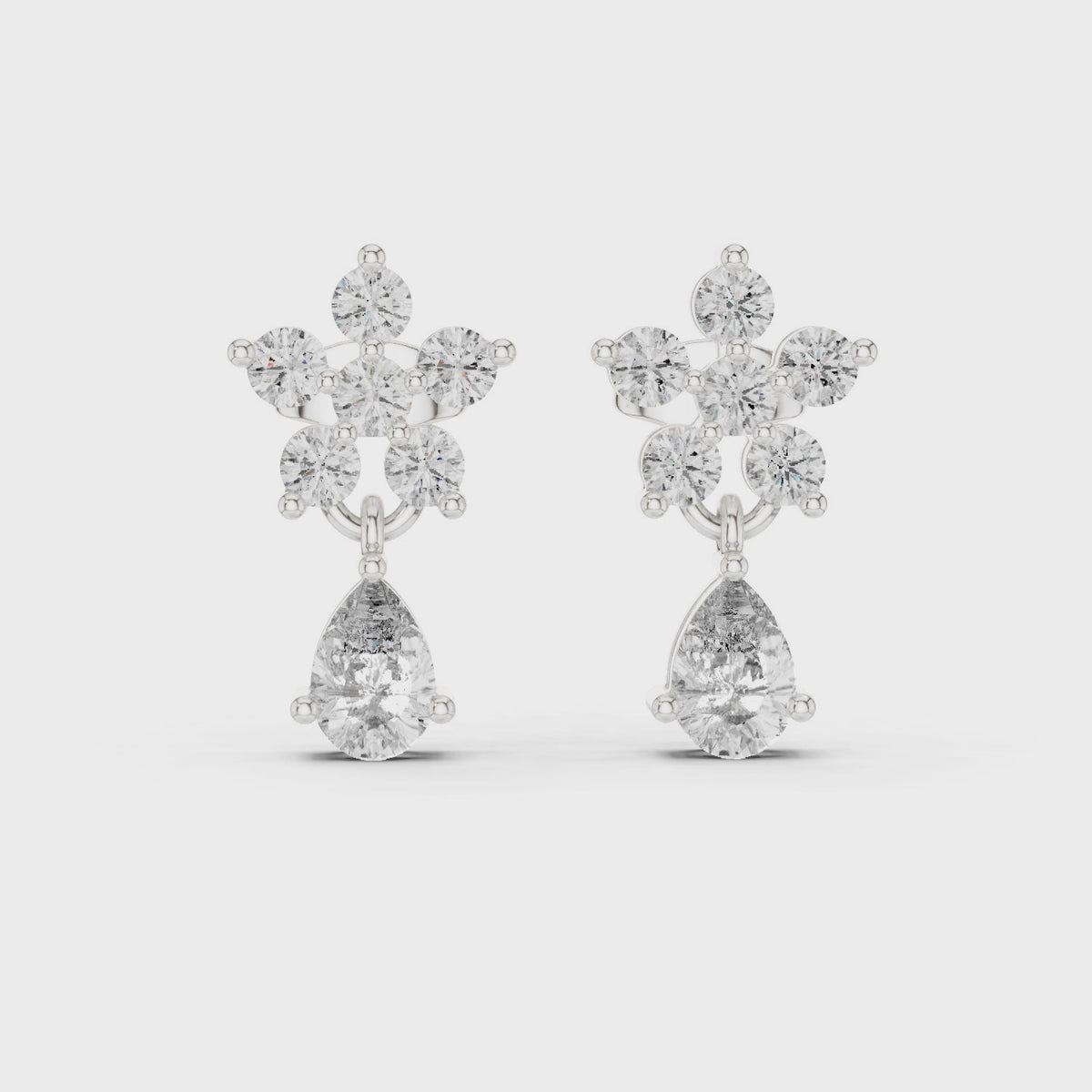 Round and pear lab-grown diamond flower drop earrings in white gold, 360 degree video